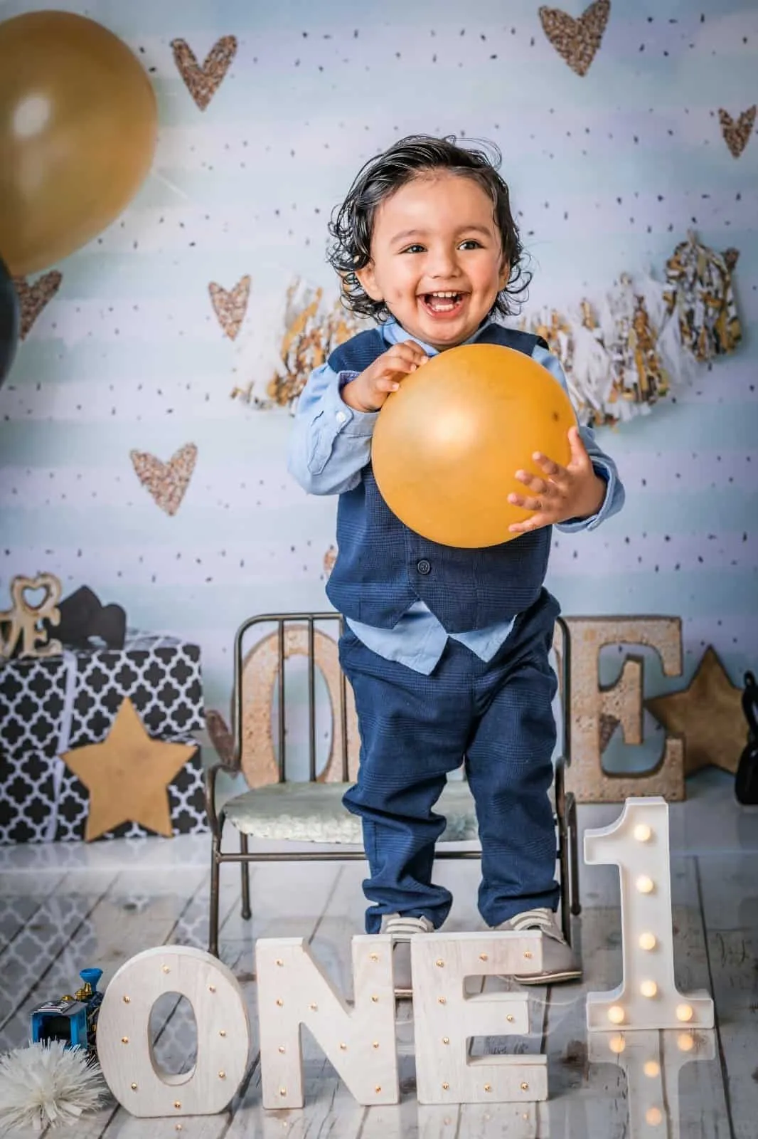 One year old boy at a first birthday cake smash photography session in Plano, Texas
